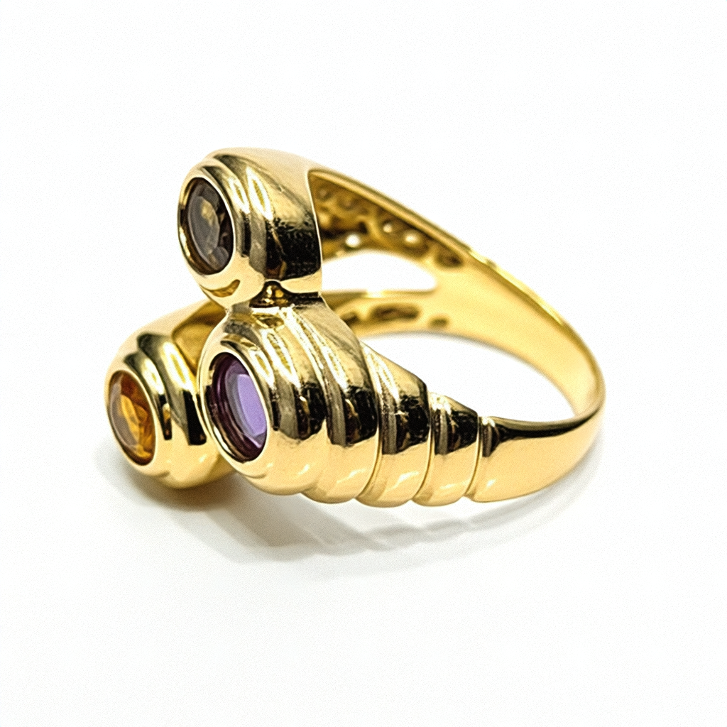 Gold ring with three gemstones on a purple surface