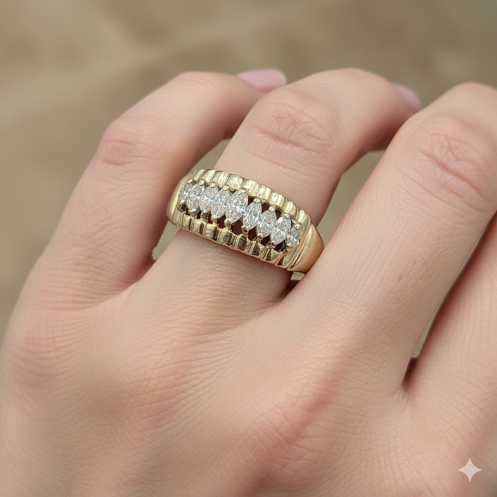 Gold ring with diamonds on a hand against a blurred background
