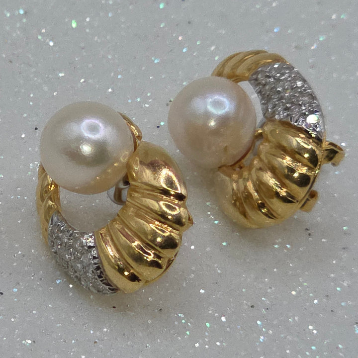 Gold hoop earrings with pearls on a glittery background