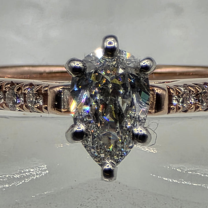 Diamond ring with a clear gemstone on a textured gray background