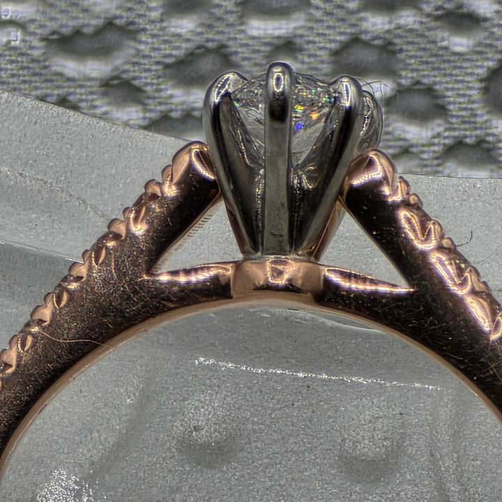 Close-up of a ring with a diamond on a textured gray background