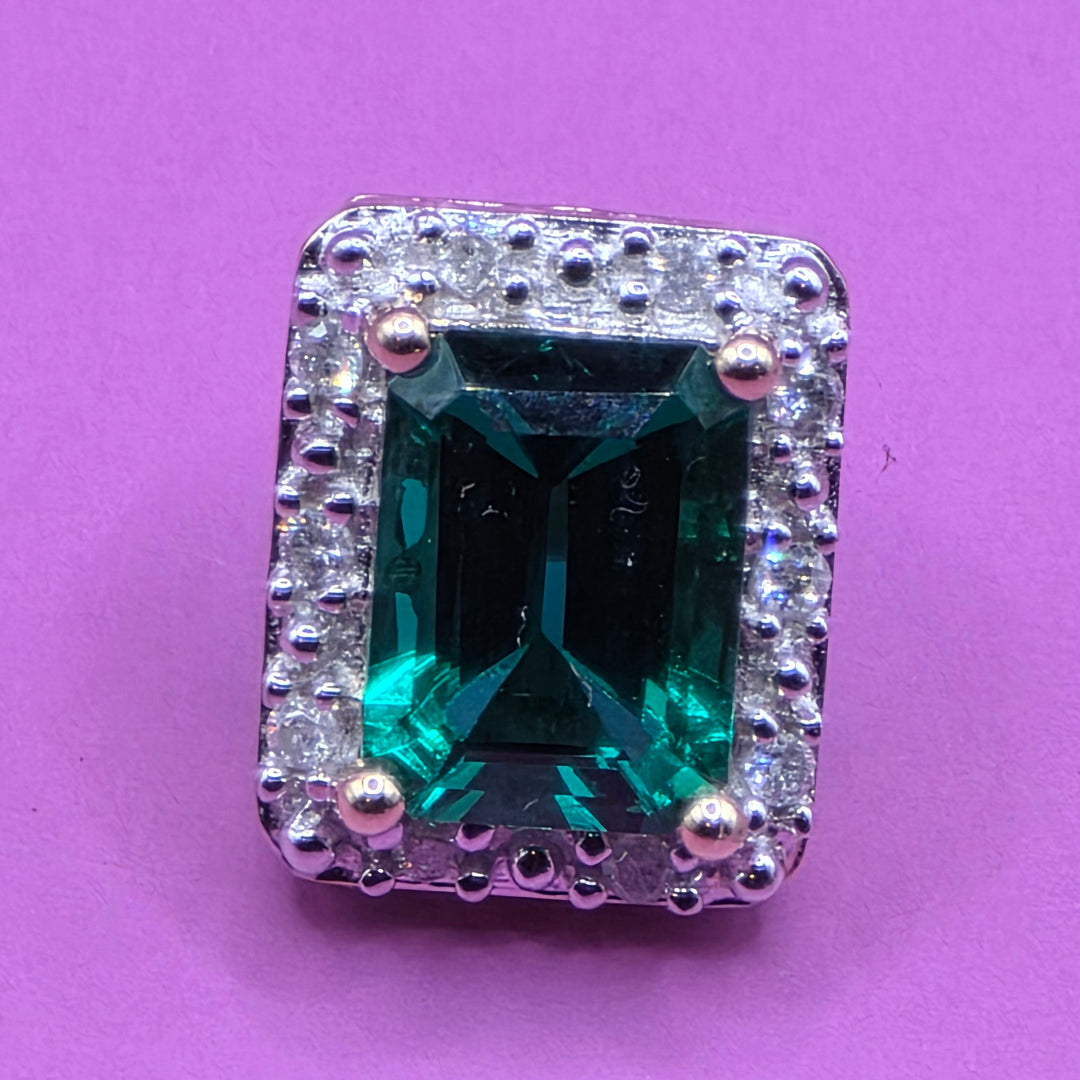 Green emerald gemstone stud earring with diamond-studded surround