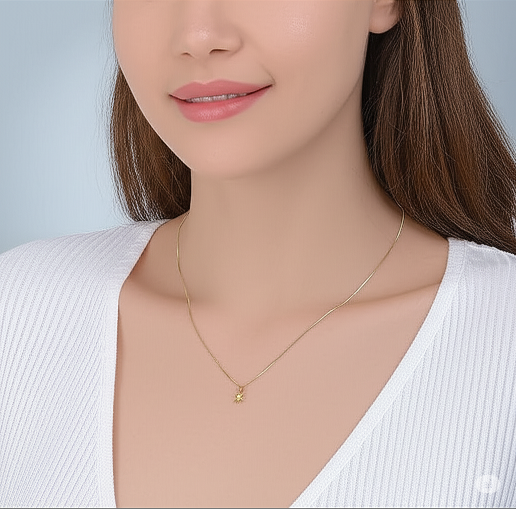 Gold necklace worn by a model against a neutral background