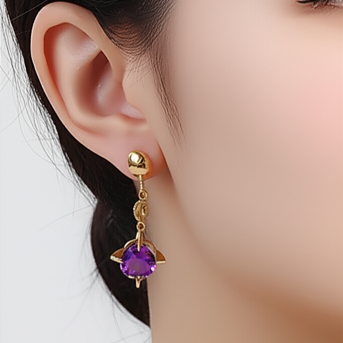 Gold earring with a purple amethyst gemstone